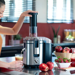 Young female making fruit juice