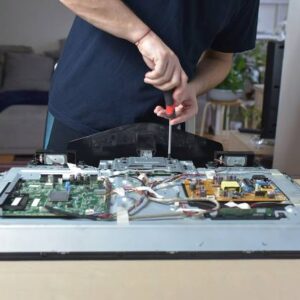 The man repairing broken tv at home